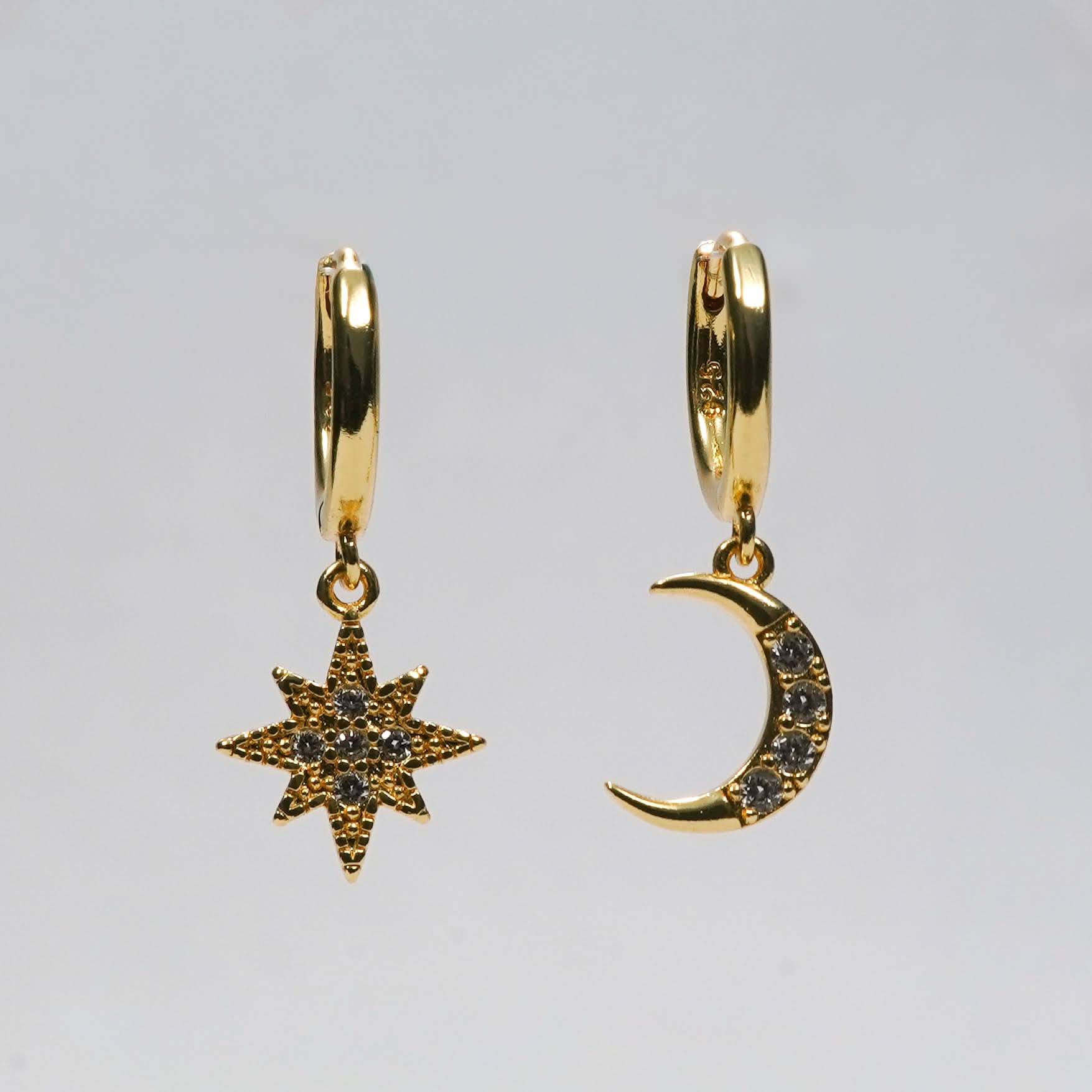 Edge Celestial Moon & Star Mismatched Huggie Earrings – CZ crescent moon and starburst huggie earrings in gold