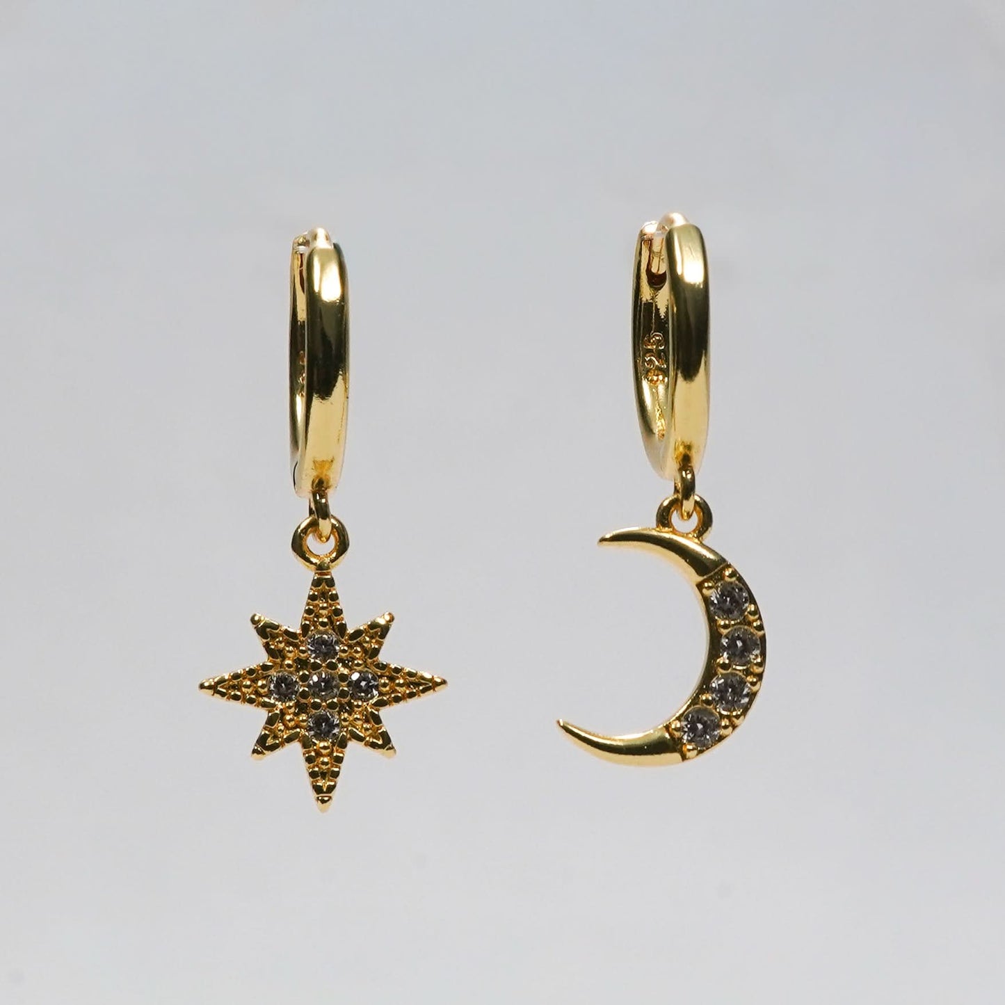 Edge Celestial Moon & Star Mismatched Huggie Earrings – CZ crescent moon and starburst huggie earrings in gold