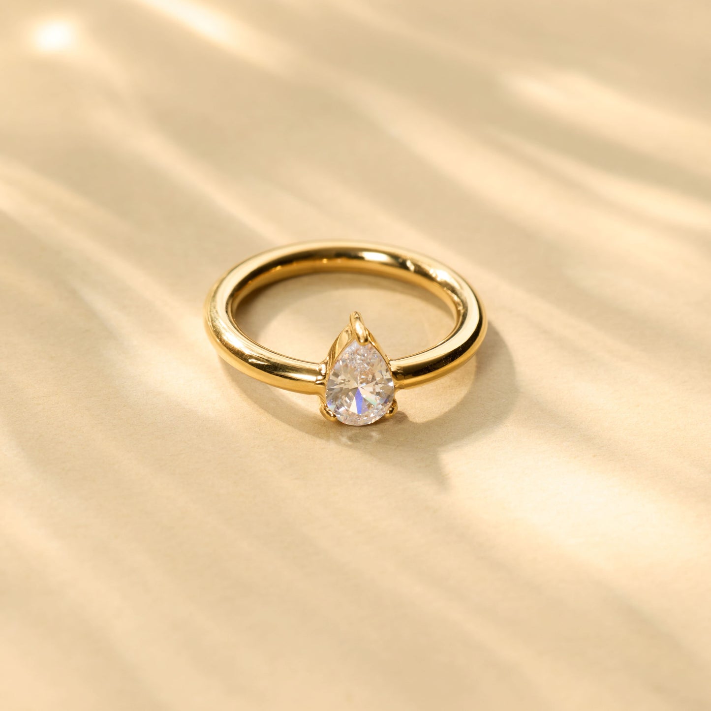 Classic pear-cut teardrop CZ solitaire ring with smooth high-polish gold-tone band-5