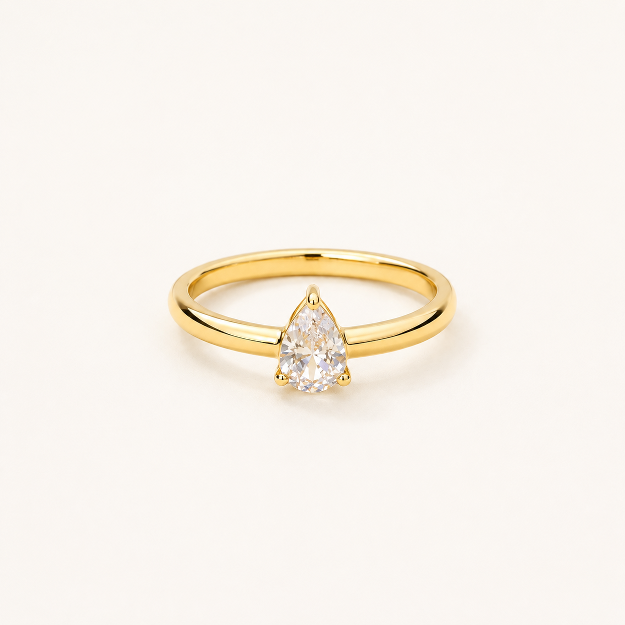 Classic pear-cut teardrop CZ solitaire ring with smooth high-polish gold-tone band
