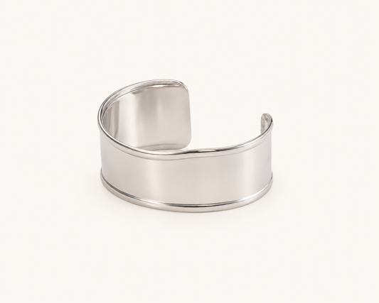 Classic wide mirror-polished open cuff bangle in silver and gold tones with sculpted silhouette