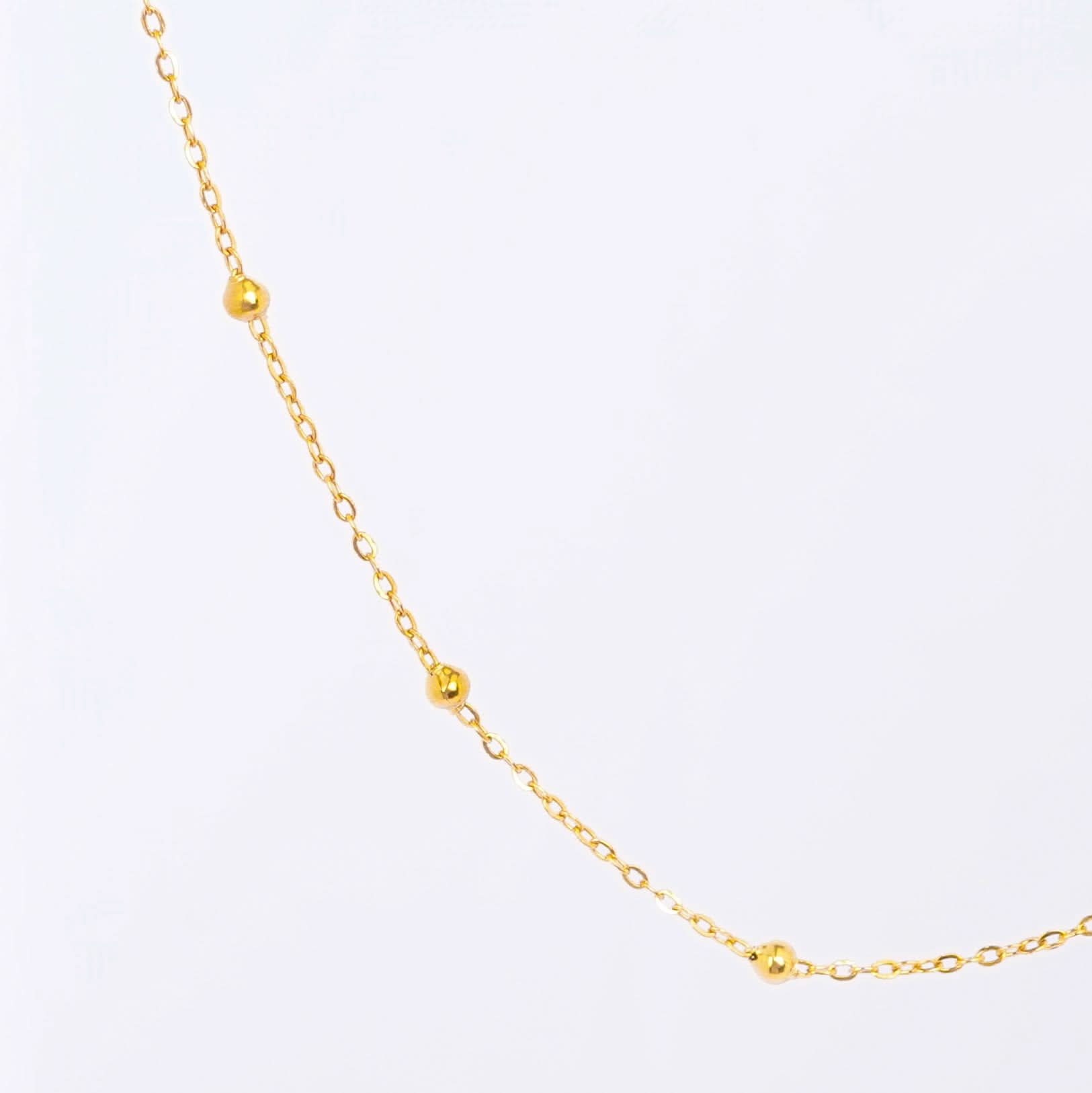 Gold Dainty Station Pendant Necklace – close-up of the delicate station pendant charms