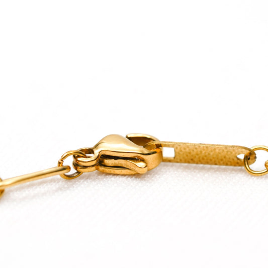 Gold Geometric Bracelet – worn on wrist, minimal structured gold bracelet