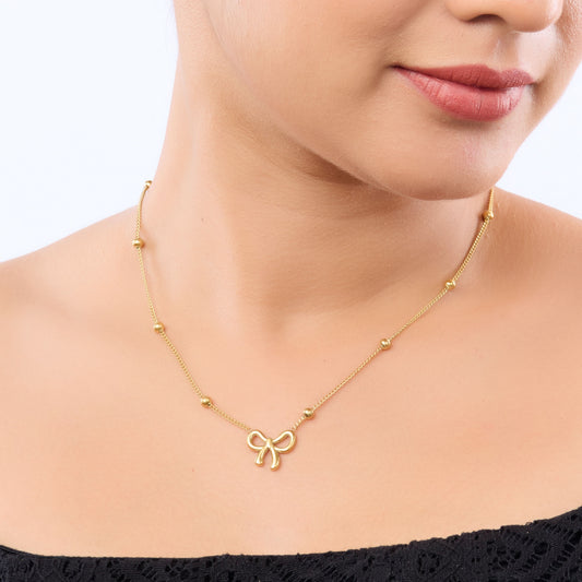 Golden Bow Charm Necklace – close-up of the bow knot silhouette
