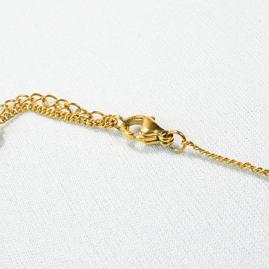 Golden Bow Charm Necklace – worn on neckline, street-style bow charm necklace