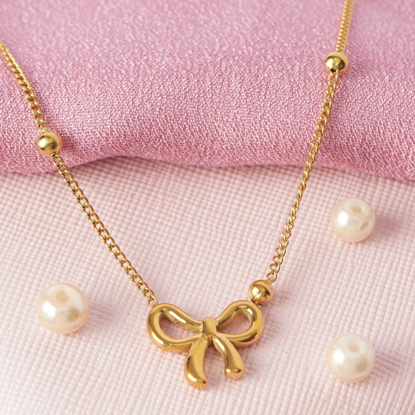 Golden Bow Charm Necklace – lifestyle shot styled for everyday wear