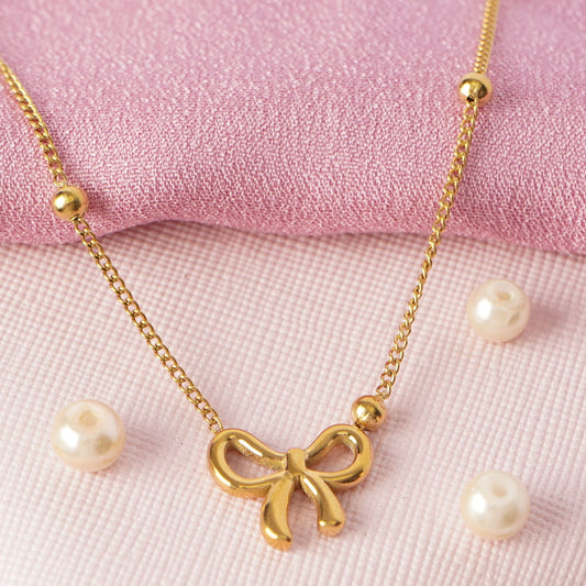 Golden Bow Charm Necklace – lifestyle shot styled for everyday wear